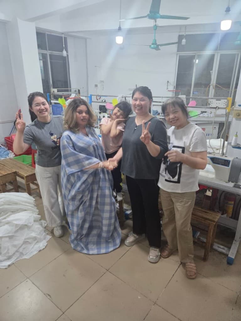 Queen with her manufacturing team in China